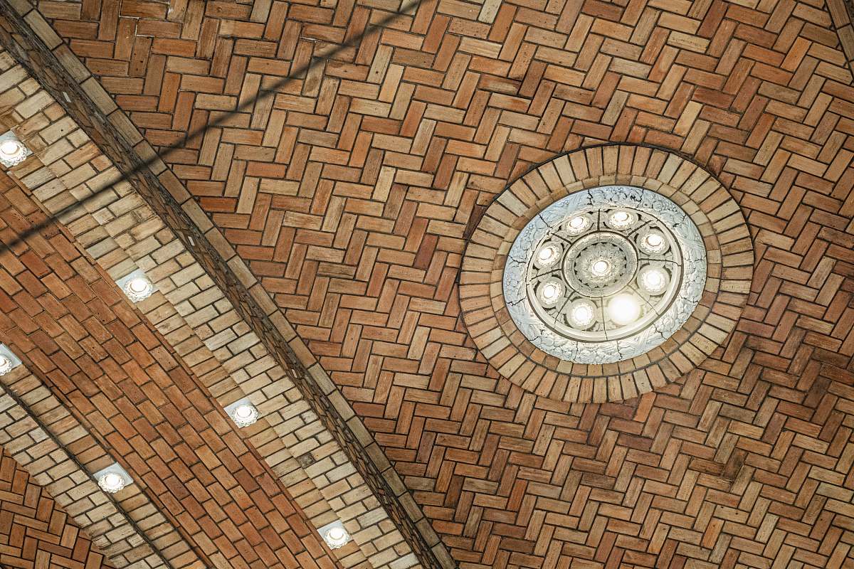 clock tower brown tiled building walls and ceiling tower